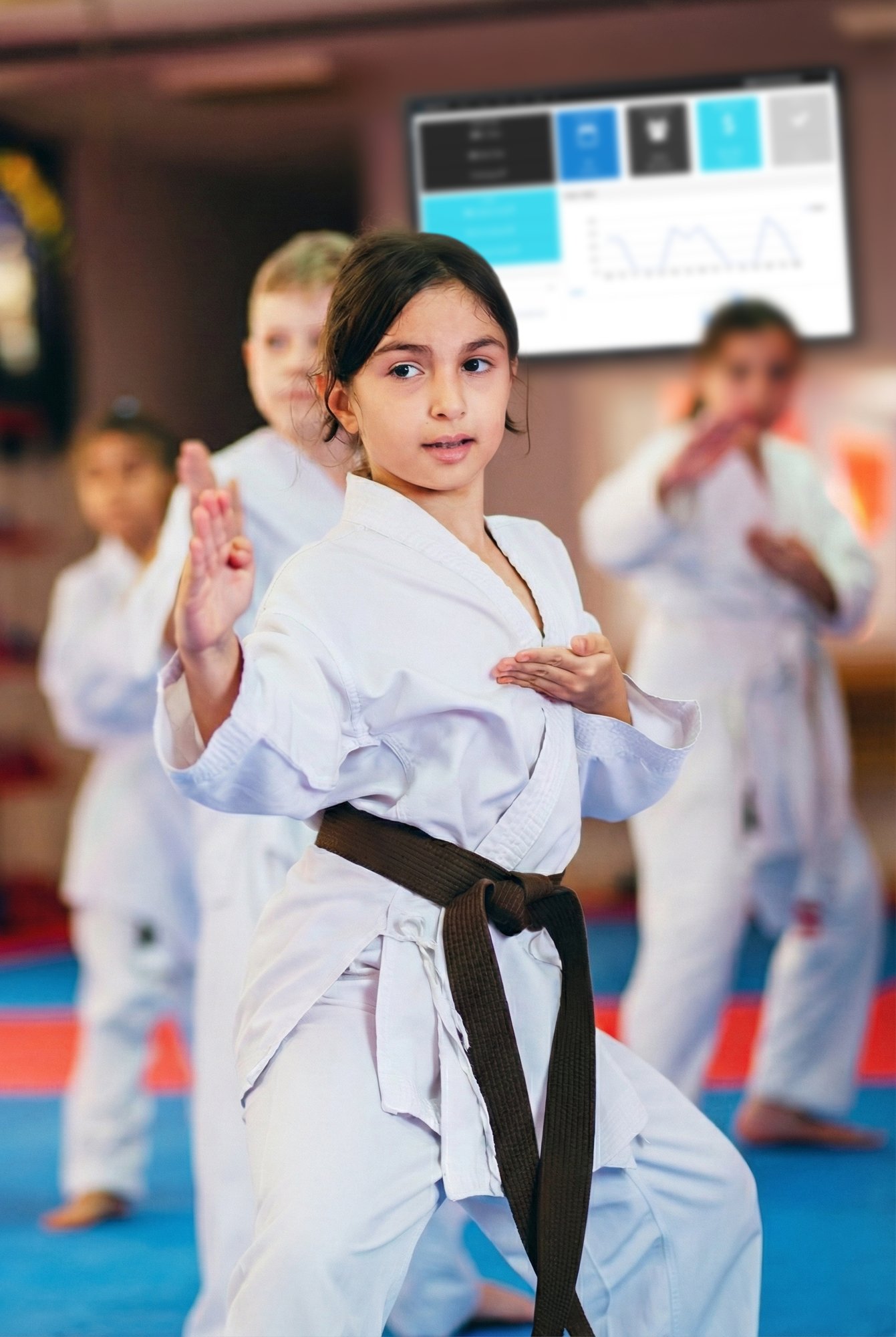 Kids in a karate class with Studio Pro martial arts software projected in the background