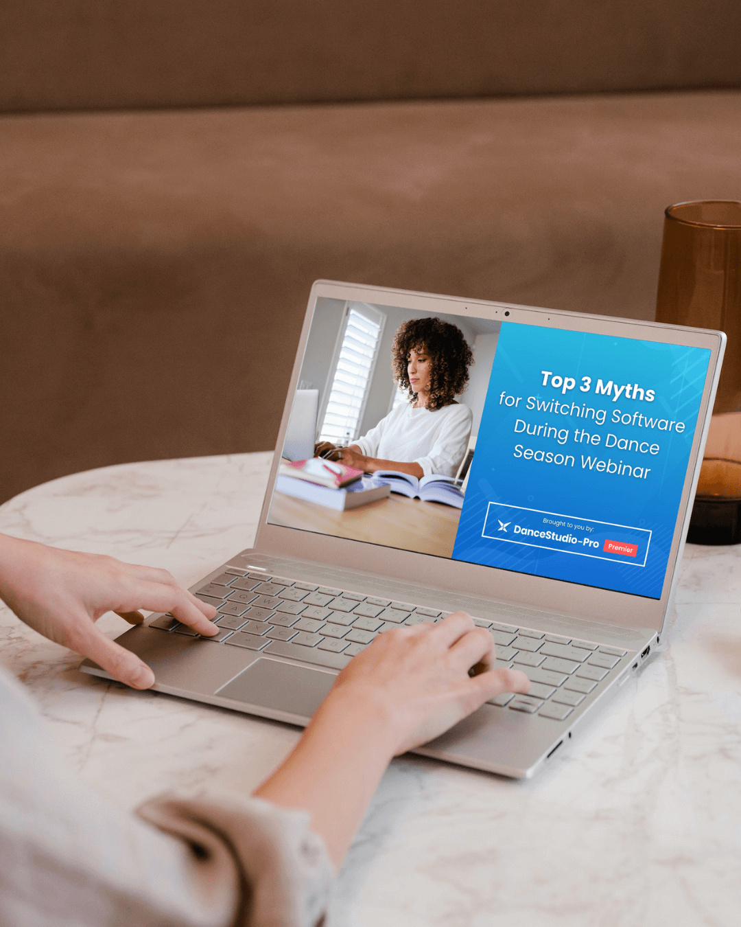 Someone watching a Studio Pro webinar on a laptop